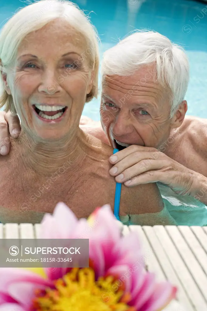 Germany, Senior couple in pool ,having fun close-up