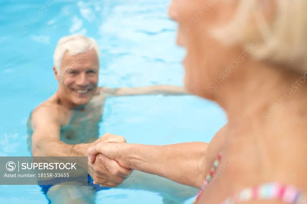 Germany, Senior couple in swimming pool