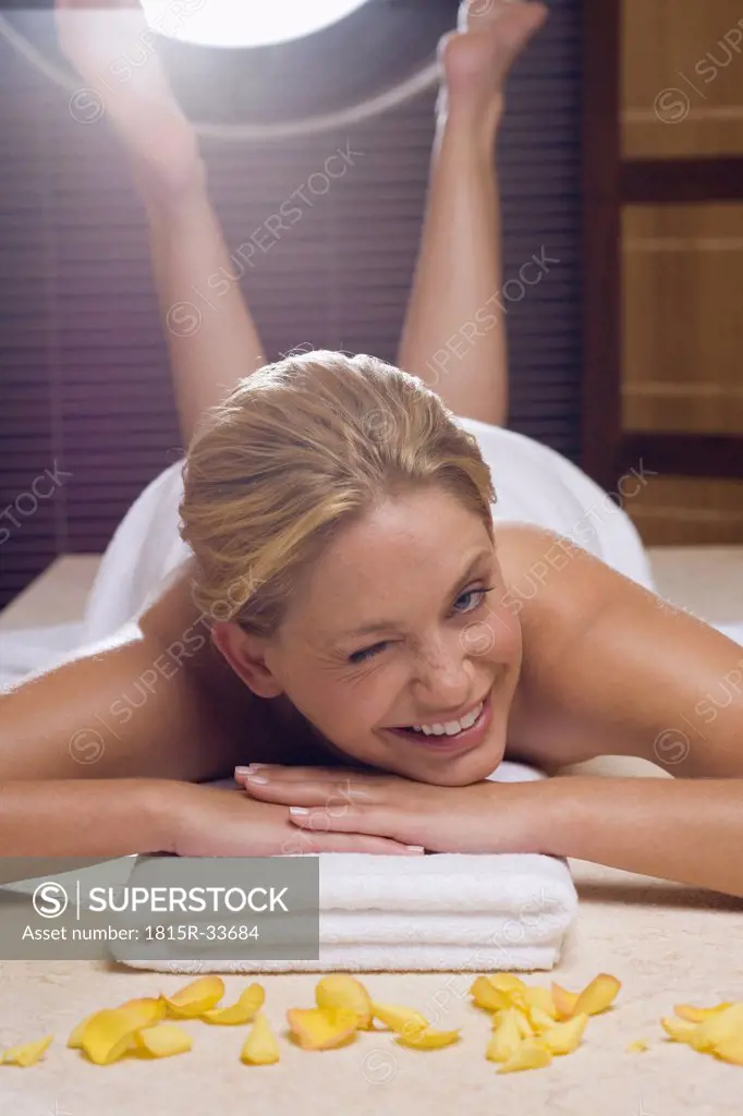 Germany, young woman lying on massage table