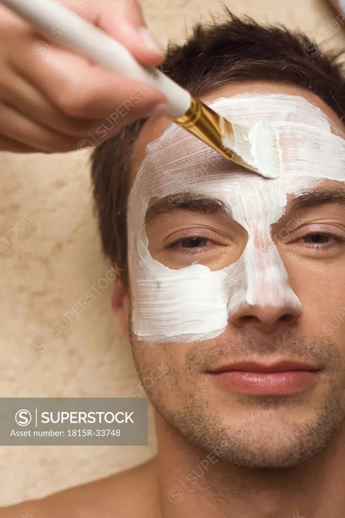 Germany, man getting a facial, close-up