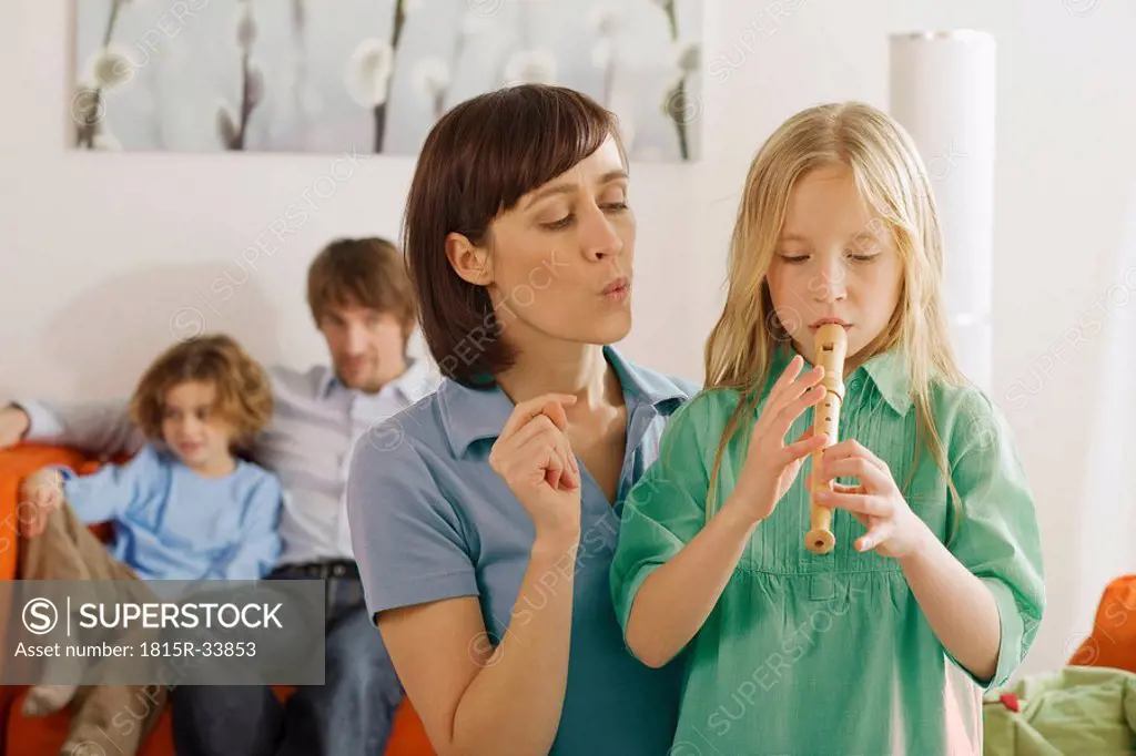 Mother and daughter 8_9, playing recorder