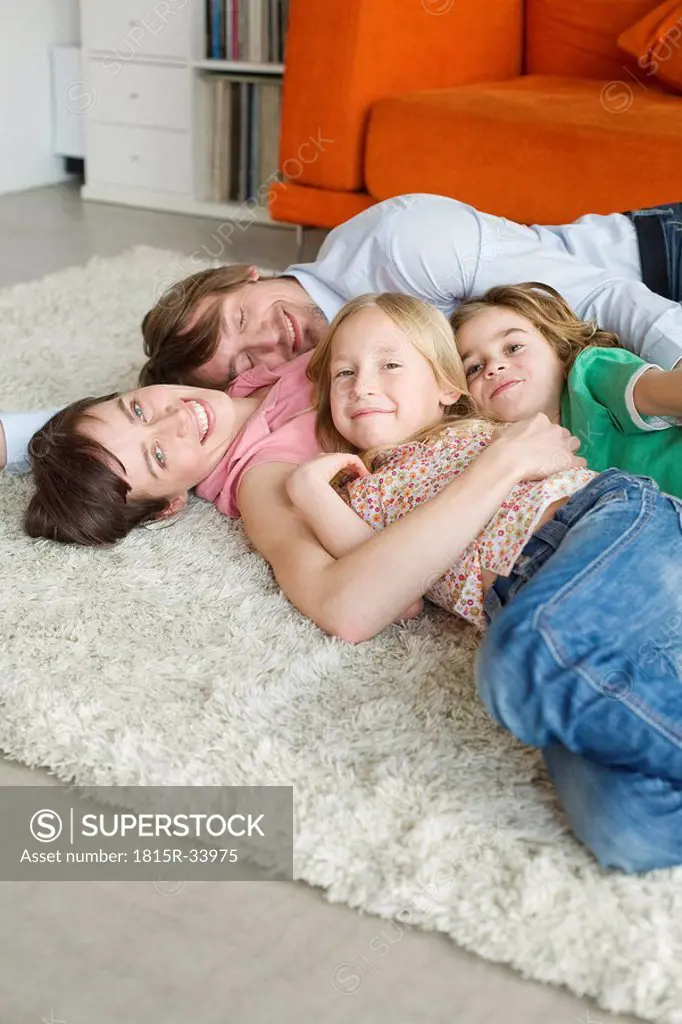 Family lying on floor in living room