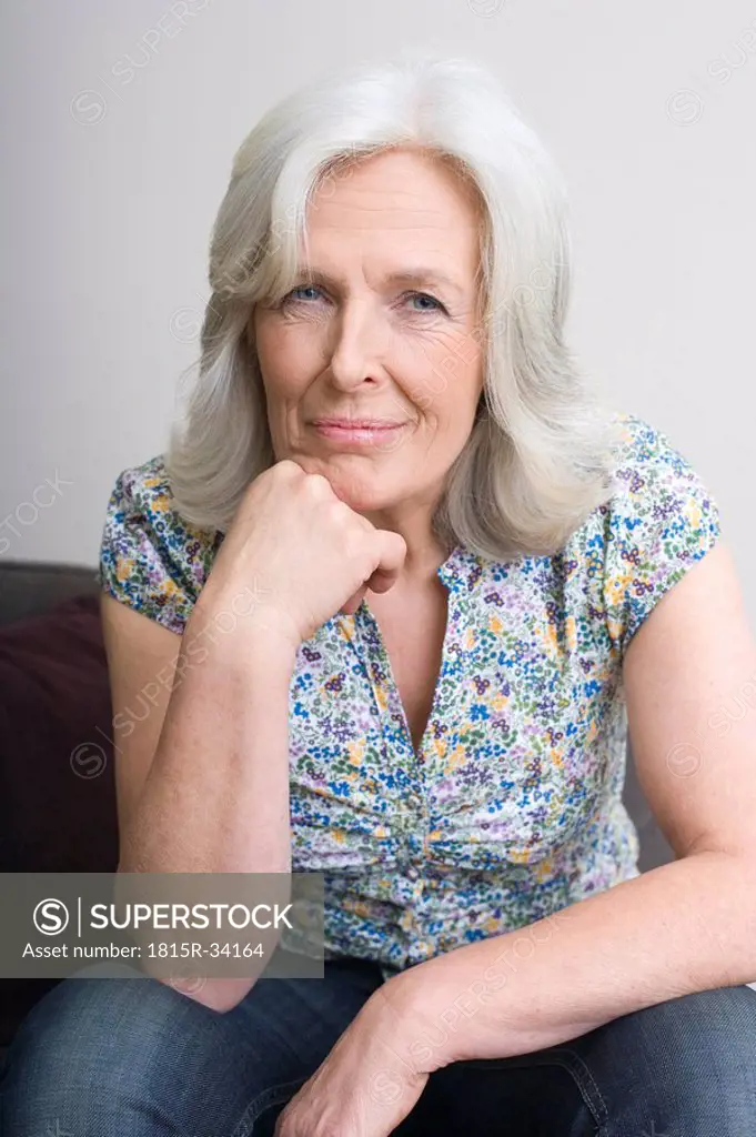 Senior woman, hand on chin, portrait