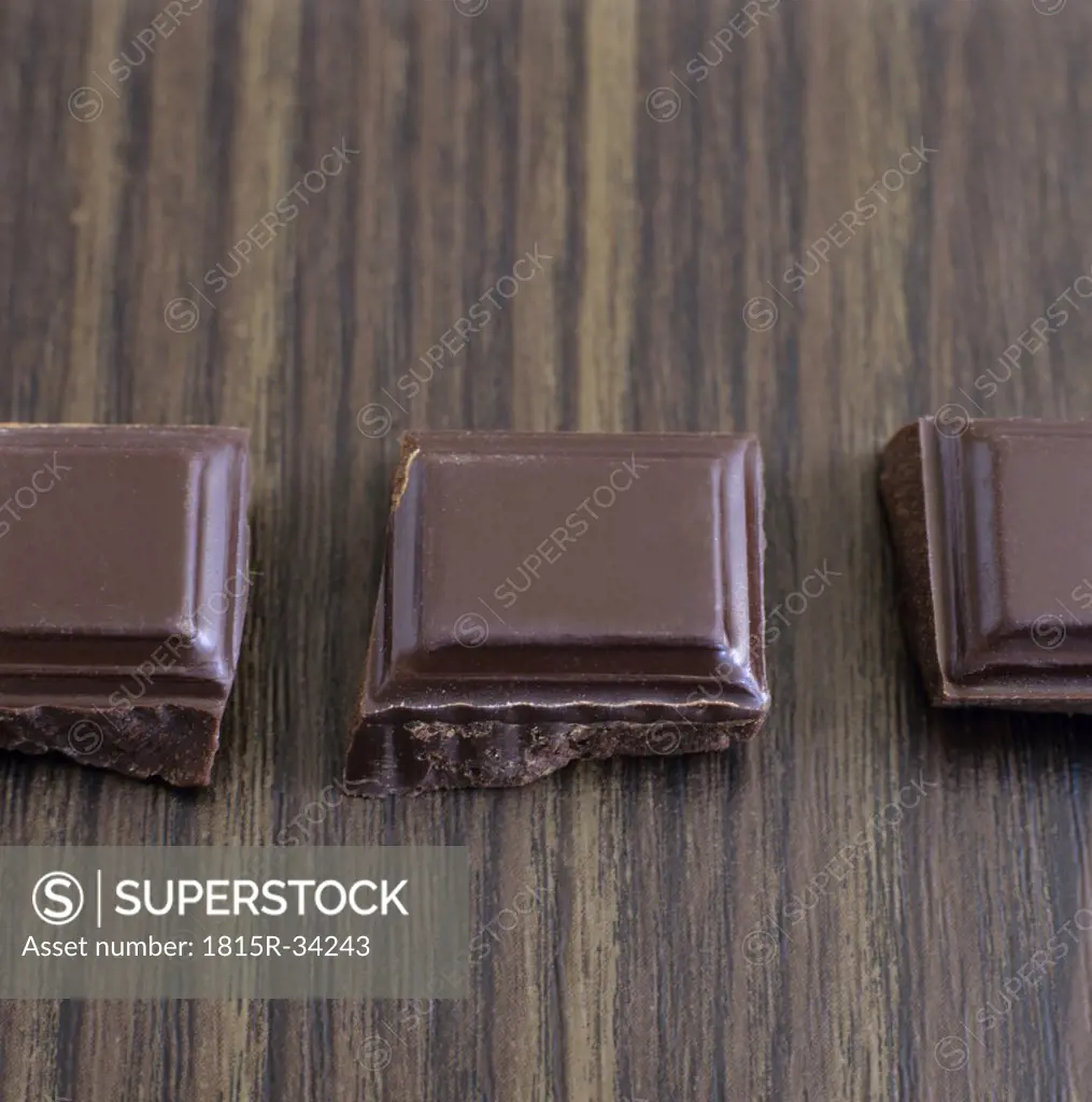 Chocolate pieces in a row, close-up