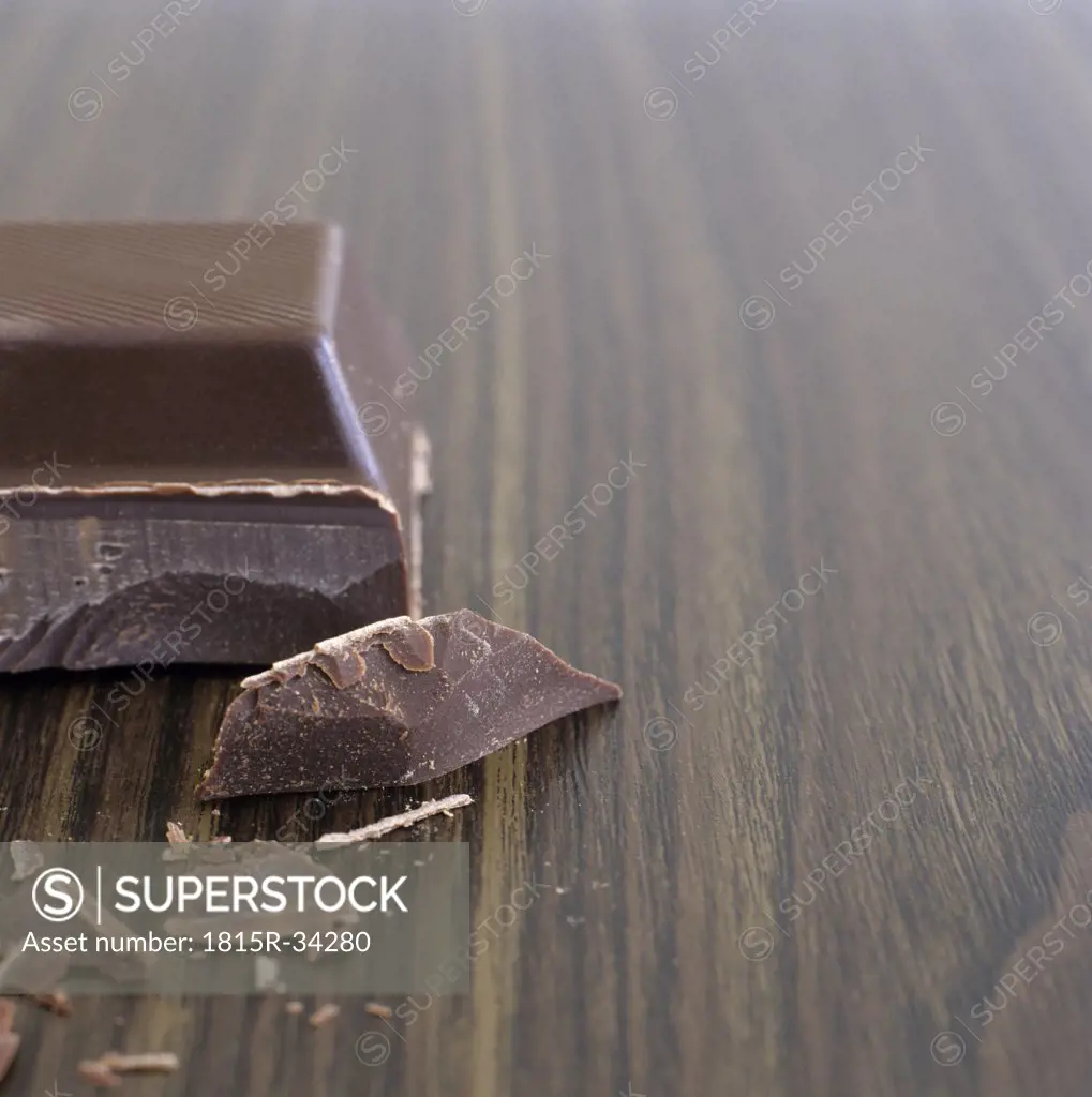 Single piece of chocolate and chocolate chips, close-up