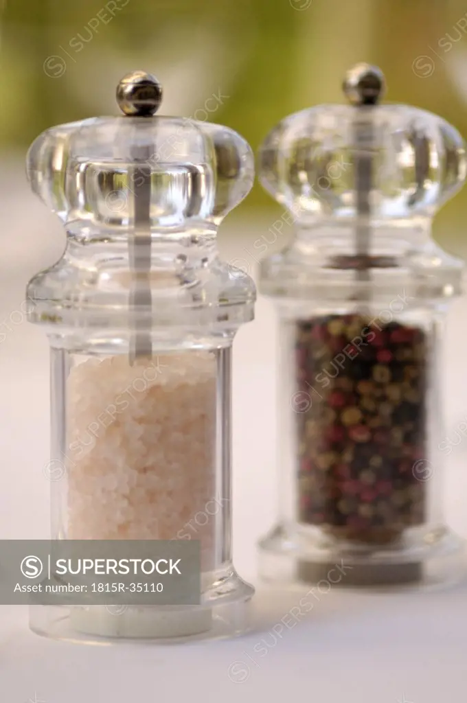 Salt mill and pepper mill on a table
