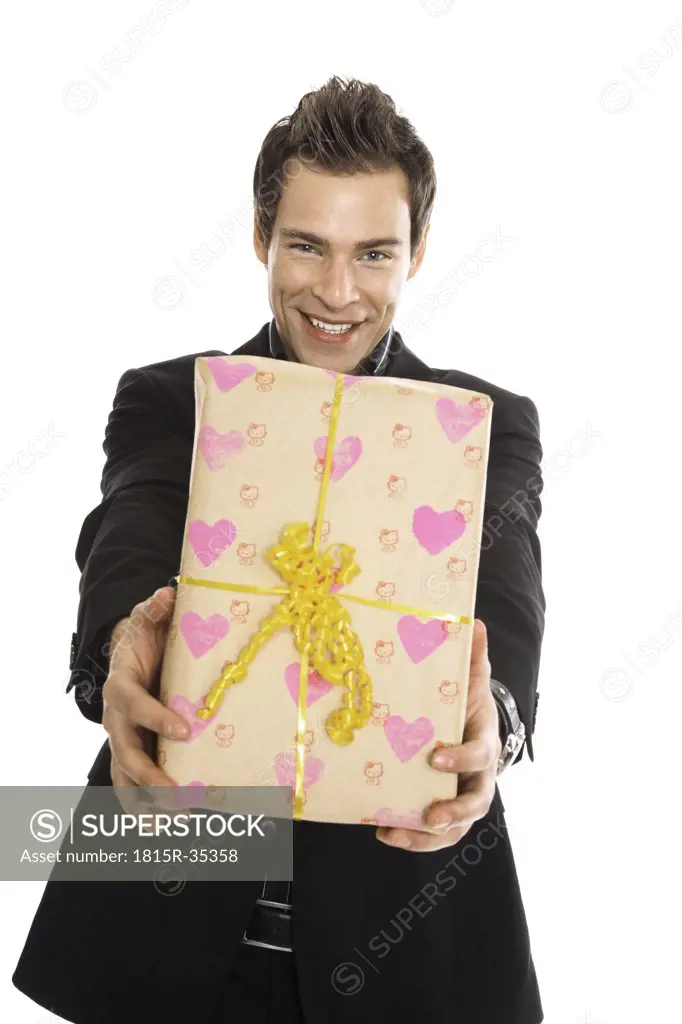 Young man holding present, close-up