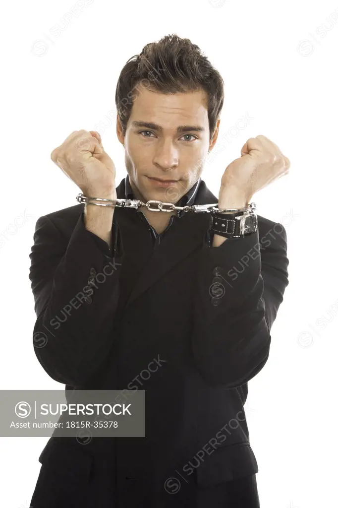 Young man wearing handcuffs, close-up