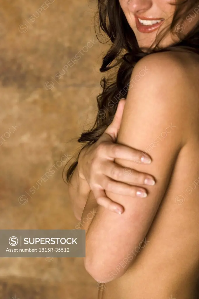 Topless woman covering bosom with both hands