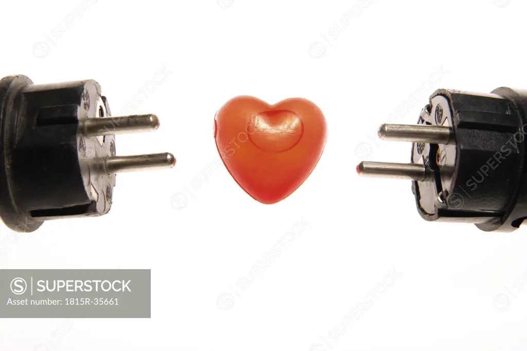 Two black plug connectors and red heart between, close-up
