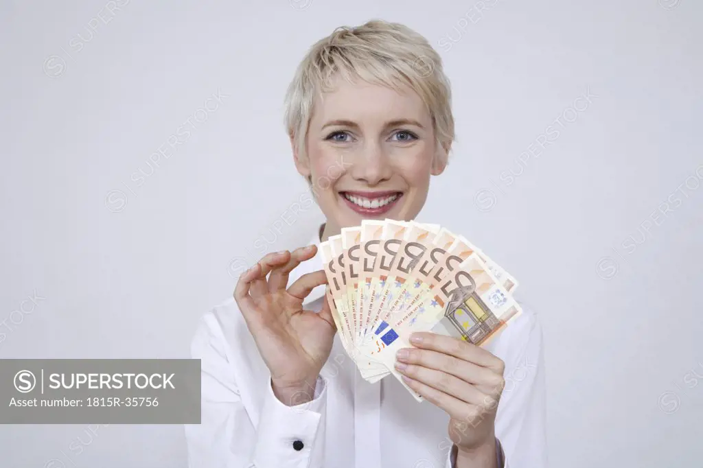 Young woman holding money, portrait