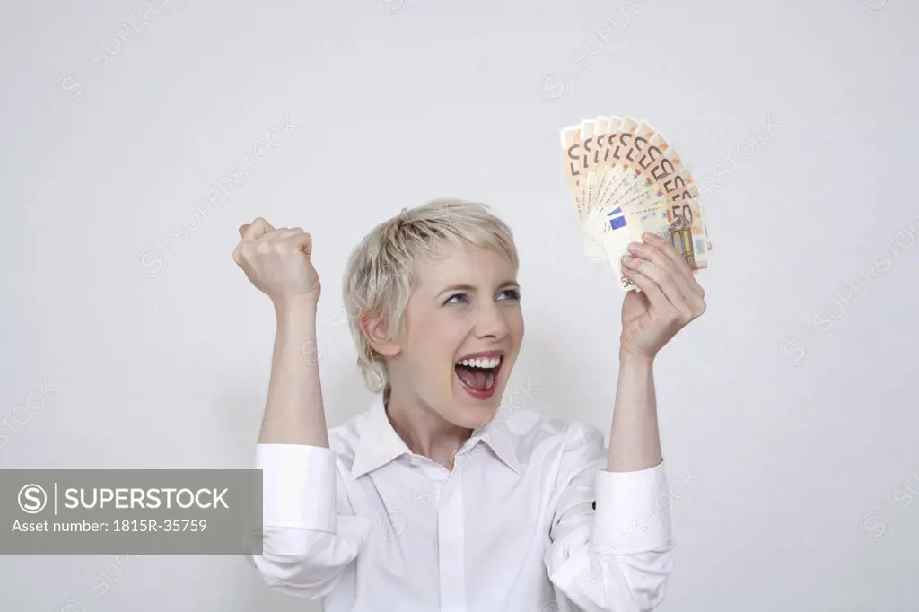 Young woman holding money, portrait