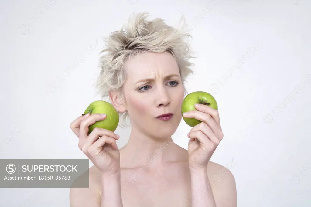 Young woman holding apples