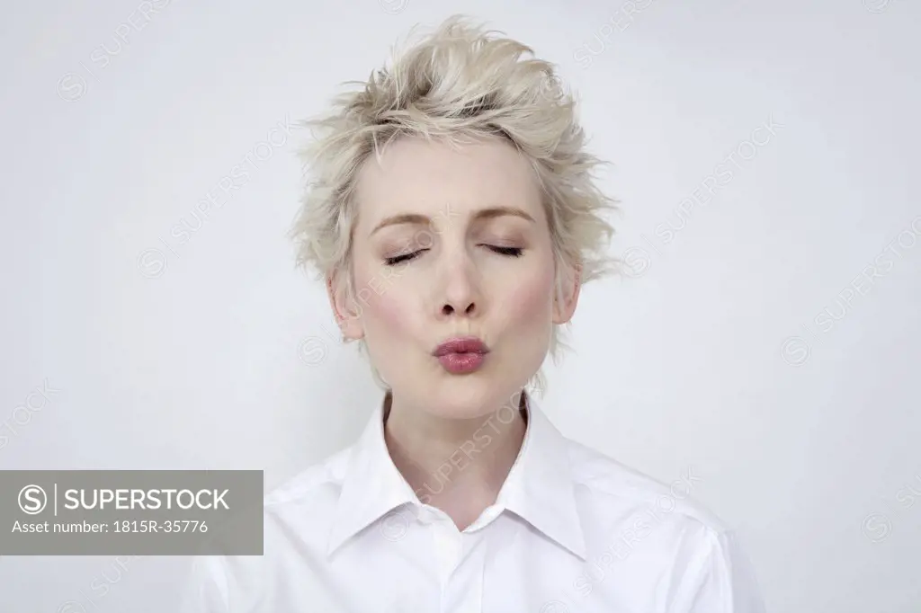 Woman puckering her lips, portrait