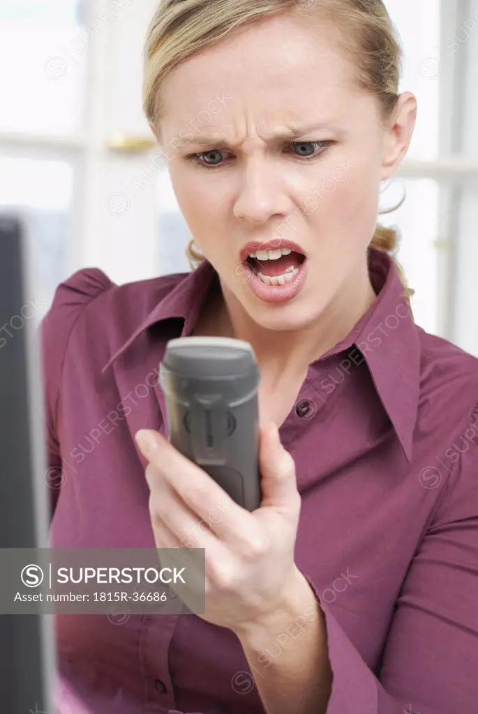 Woman shouting in telephone, close-up