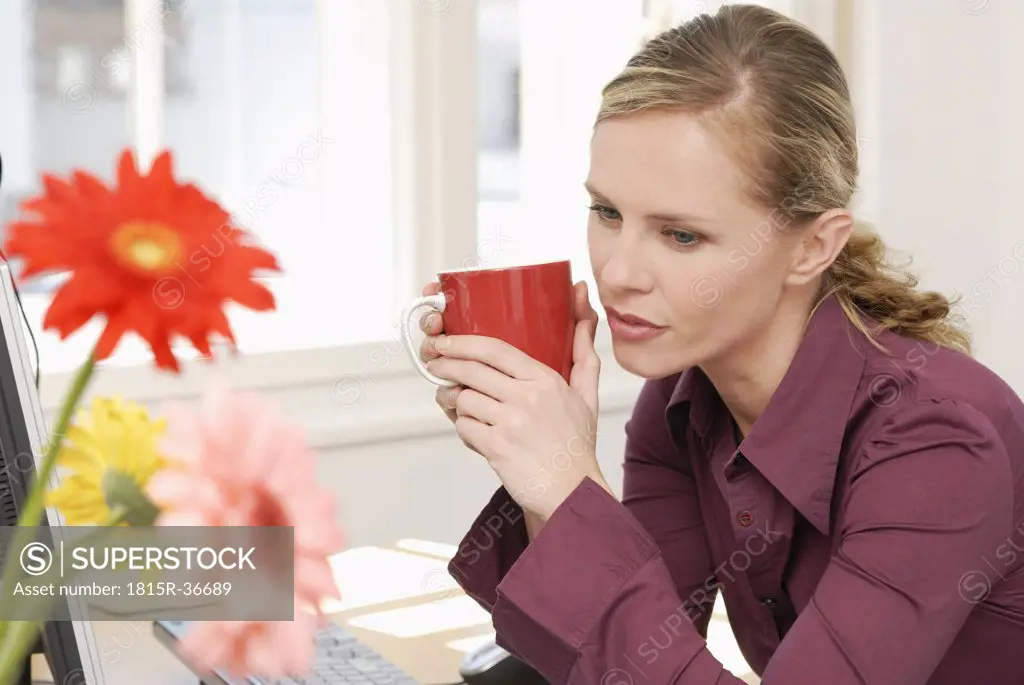 Woman sitting in office, thinking