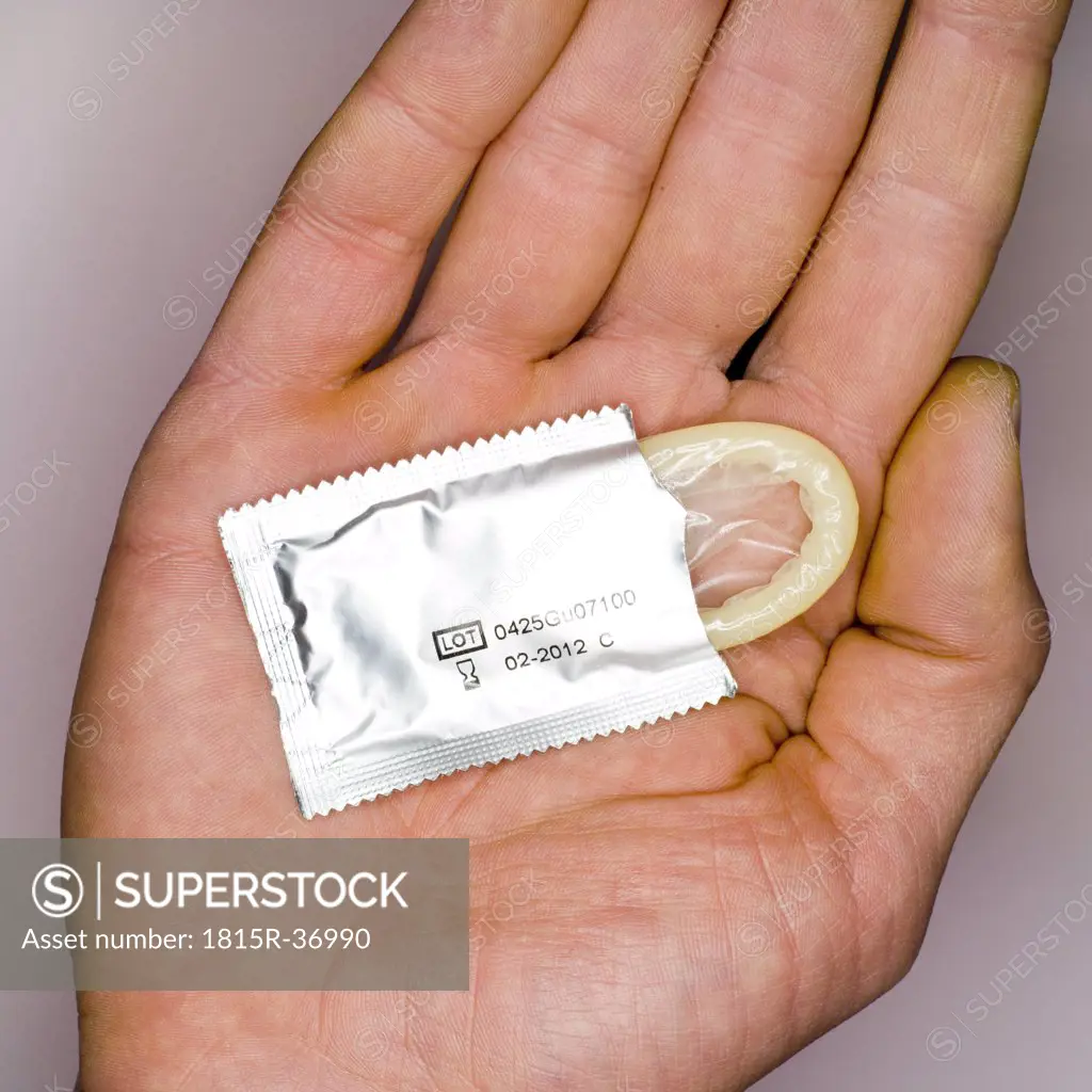 Condom on man's hand, elevated view, close-up