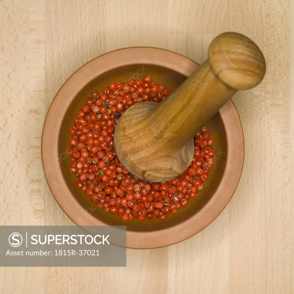 Peppercorns in mortar with pestle, elevated view