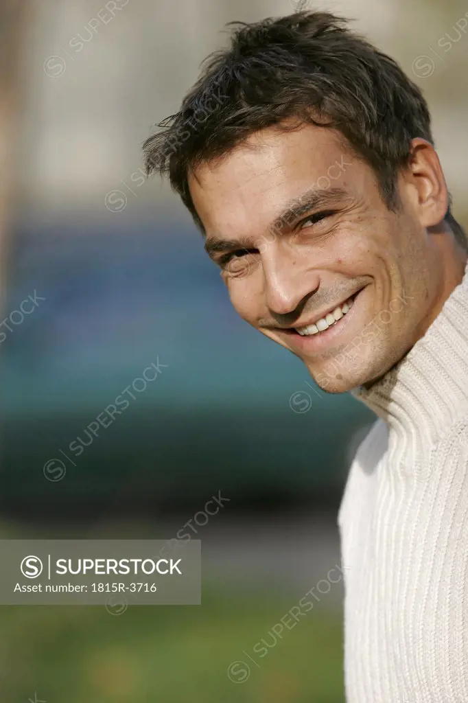 Mid adult man smiling, close-up, portrait