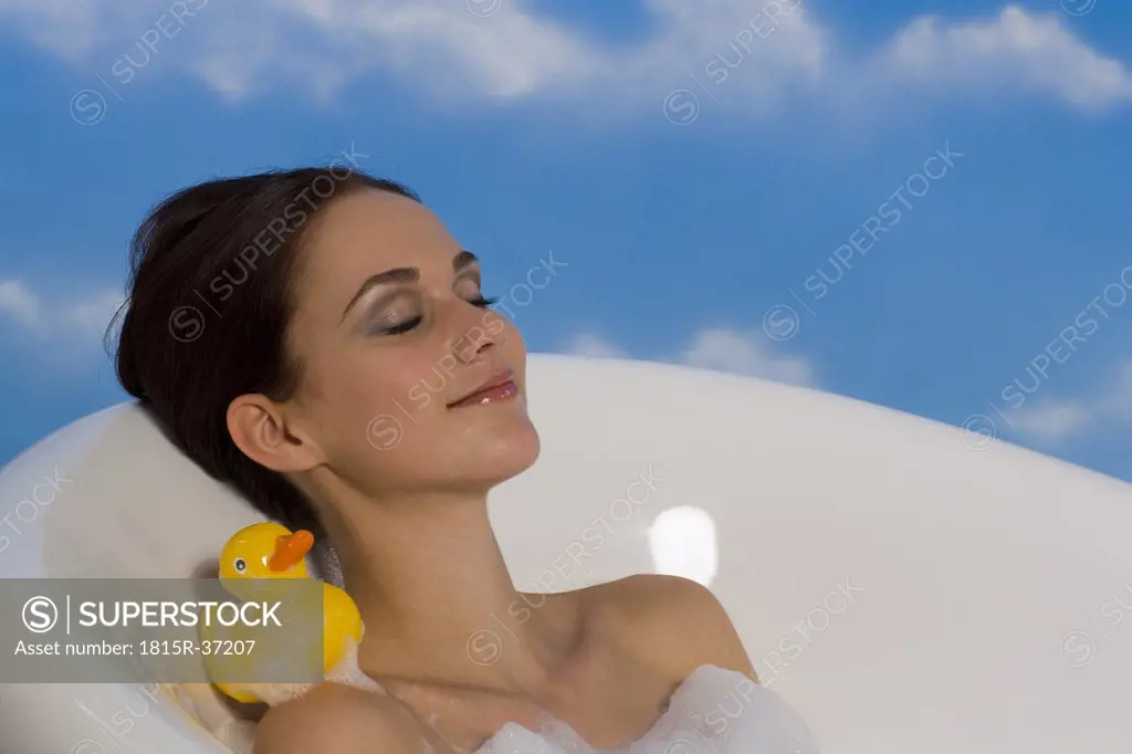 Young woman taking bubble bath