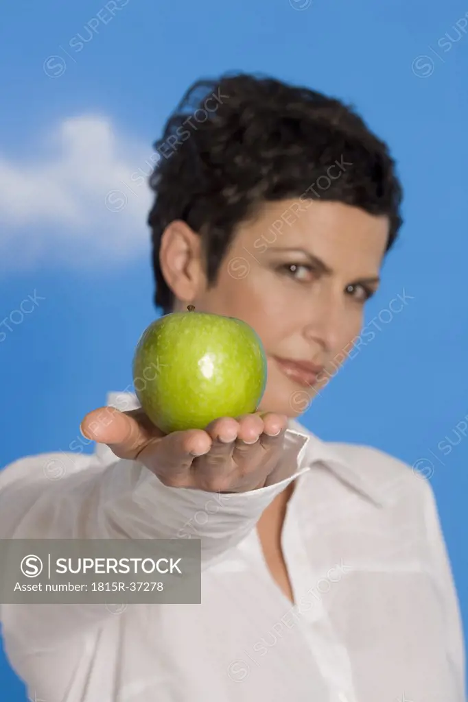 Young woman holding an apple, portrait
