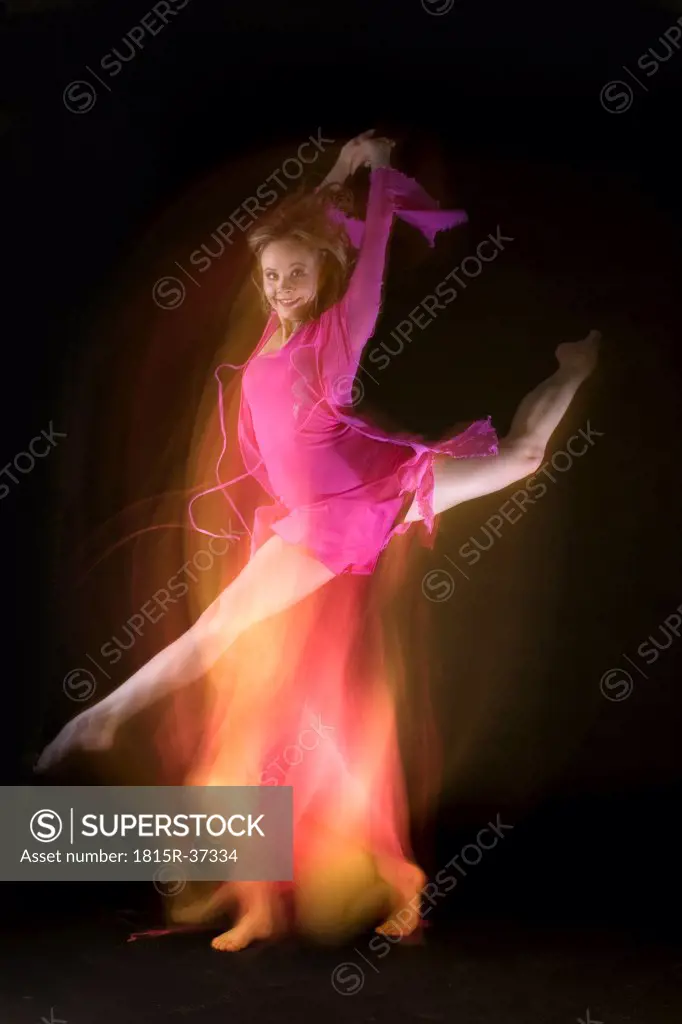 Female ballet dancer jumping in air