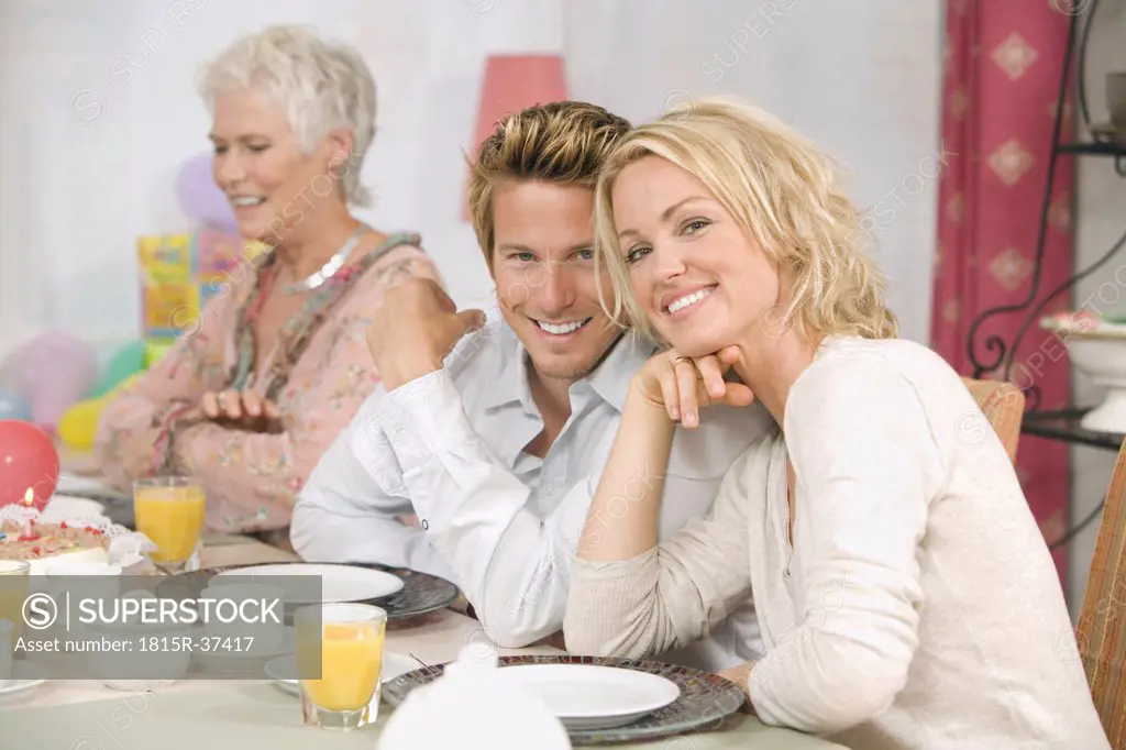 Family at dining table, smiling