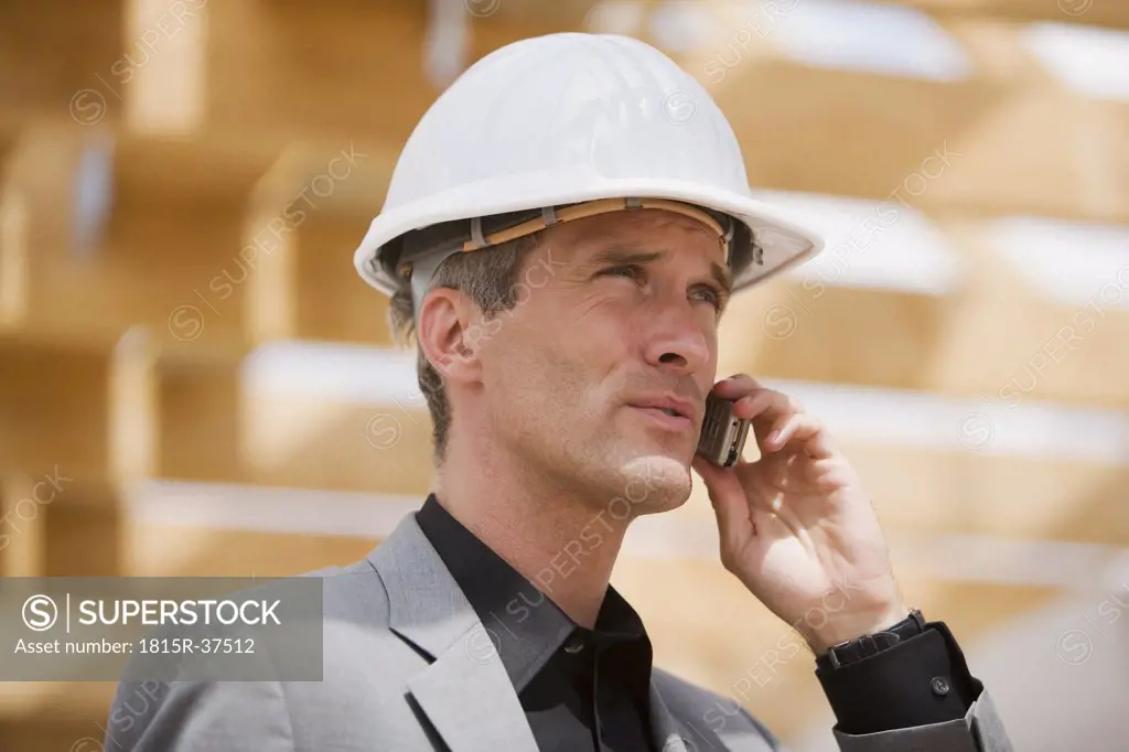 Man with hardhat talking on mobile phone