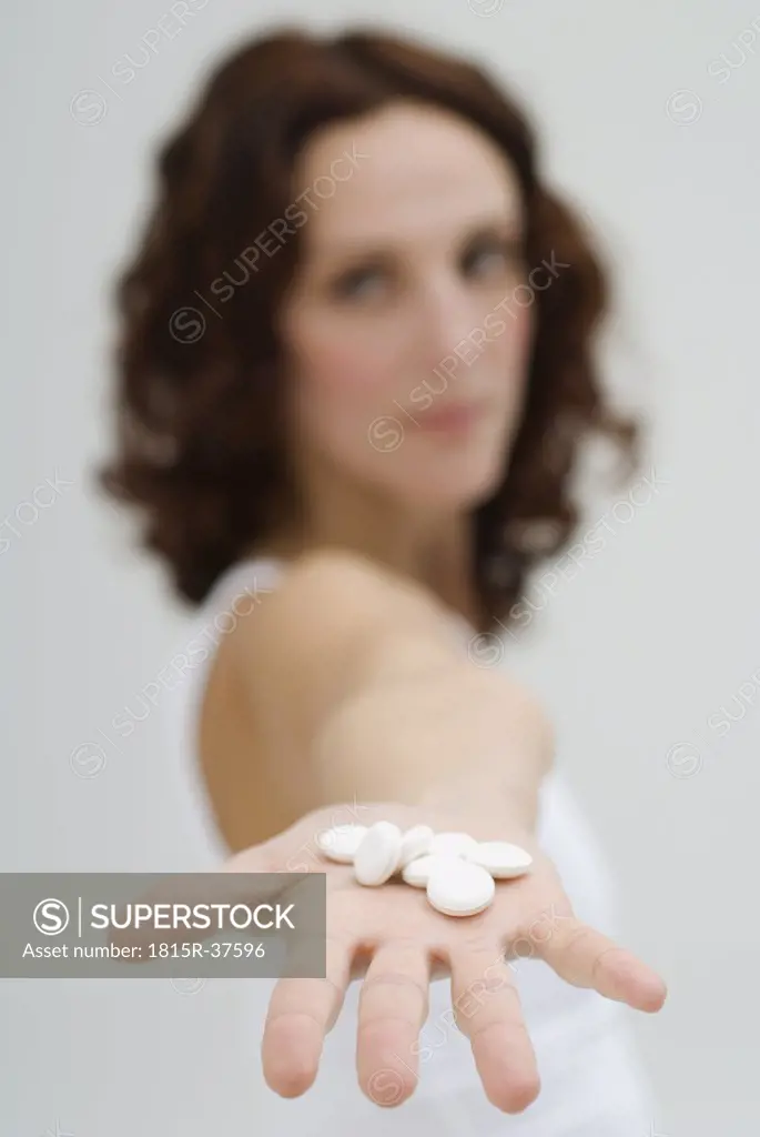 Woman holding tablets on hand, close up
