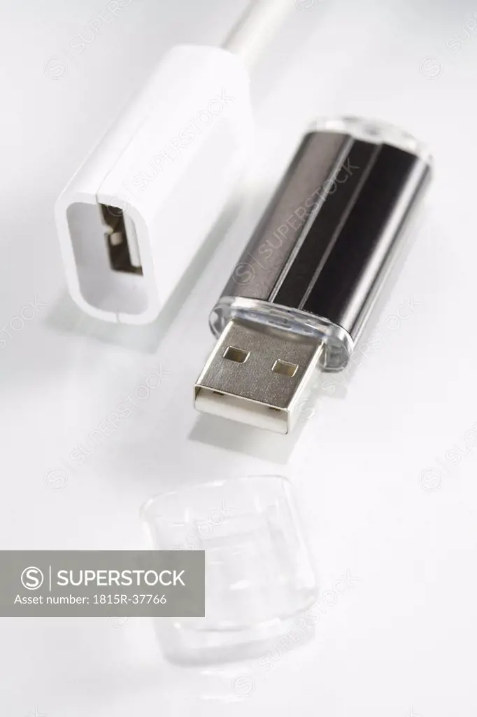 Plug and USB flash drive on white background, elevated view