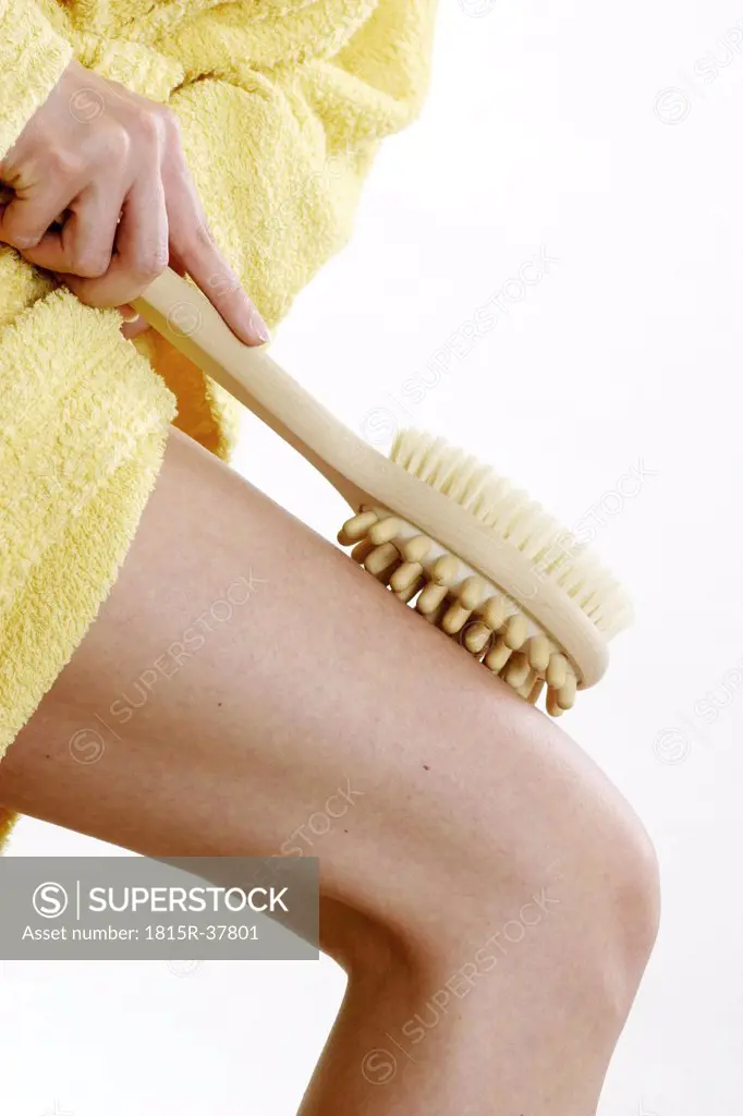 Woman with massage brush, close-up