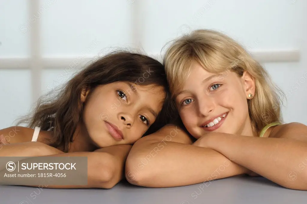 Girls (8-11) sitting head to head, close-up, portrait