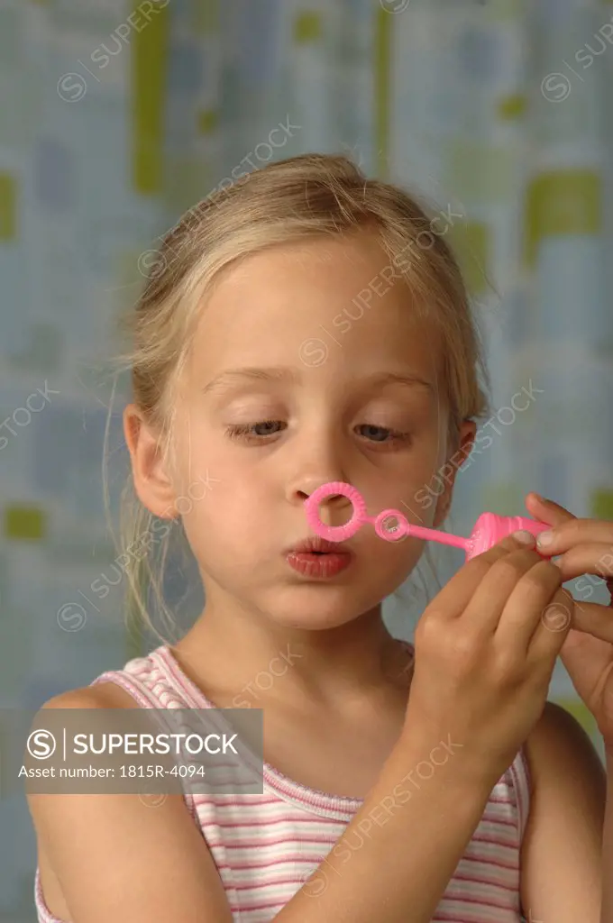 Girl making soap bubbles