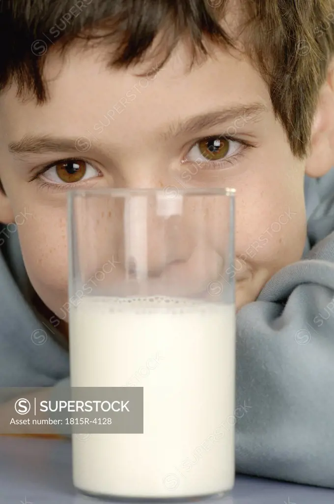 Boy (8-9) with glass of milk, close-up, portrait
