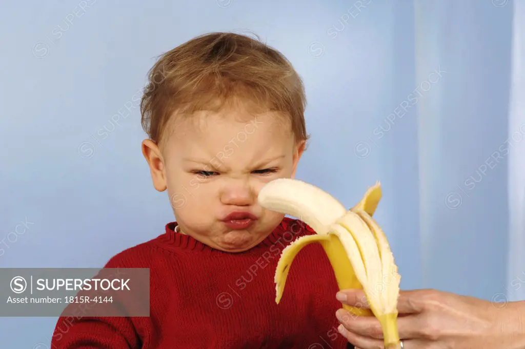 Boy (2-3) rejecting banana