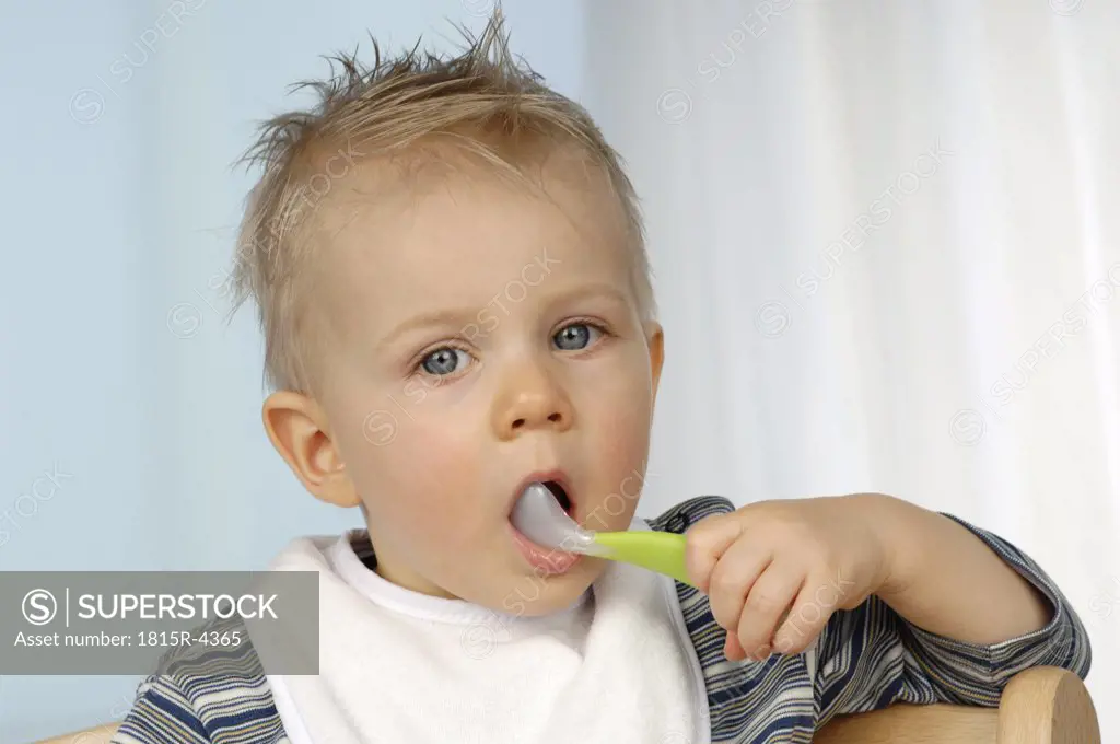 Boy (1-2), spoon in mouth, portrait