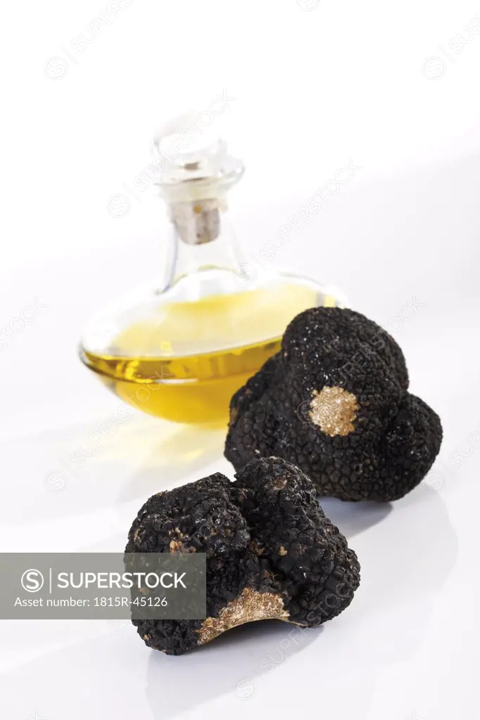 Black Truffles and a bottle of oil, close-up
