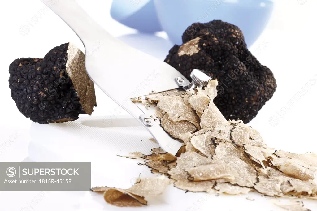 Black truffle being sliced, close-up