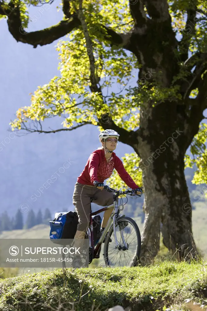 Austria, Tyrol, Ahornboden, Woman mountain biking