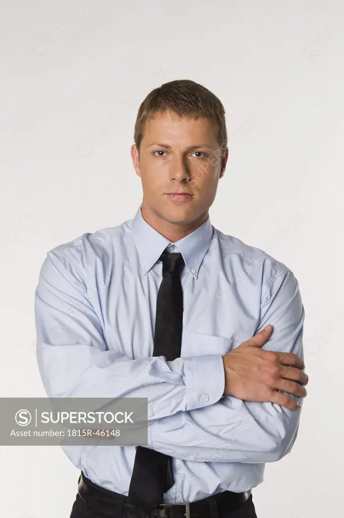Businessman standing, arms folded