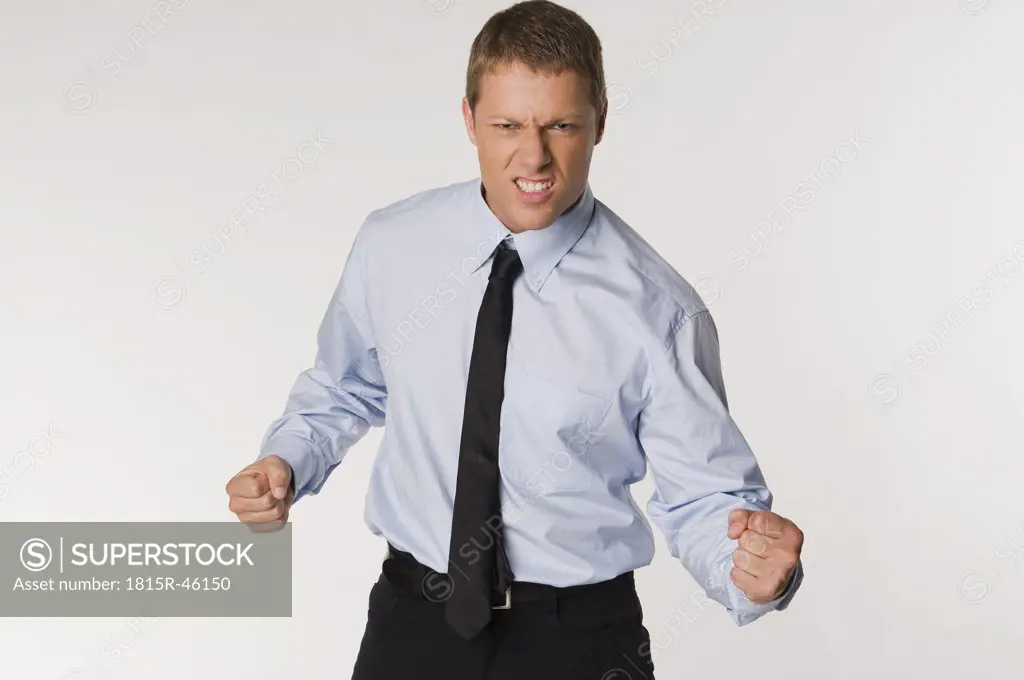 Businessman clenching fists, portrait