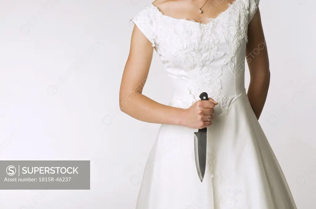 Bride holding knife, mid section