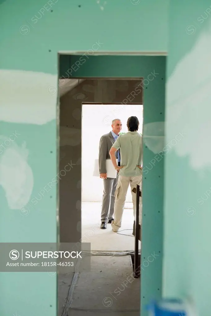 Two men talking at construction site