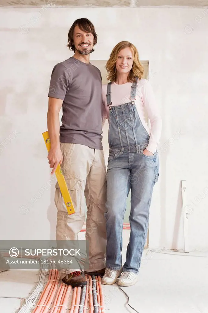 Young couple in an unfinished building, portrait