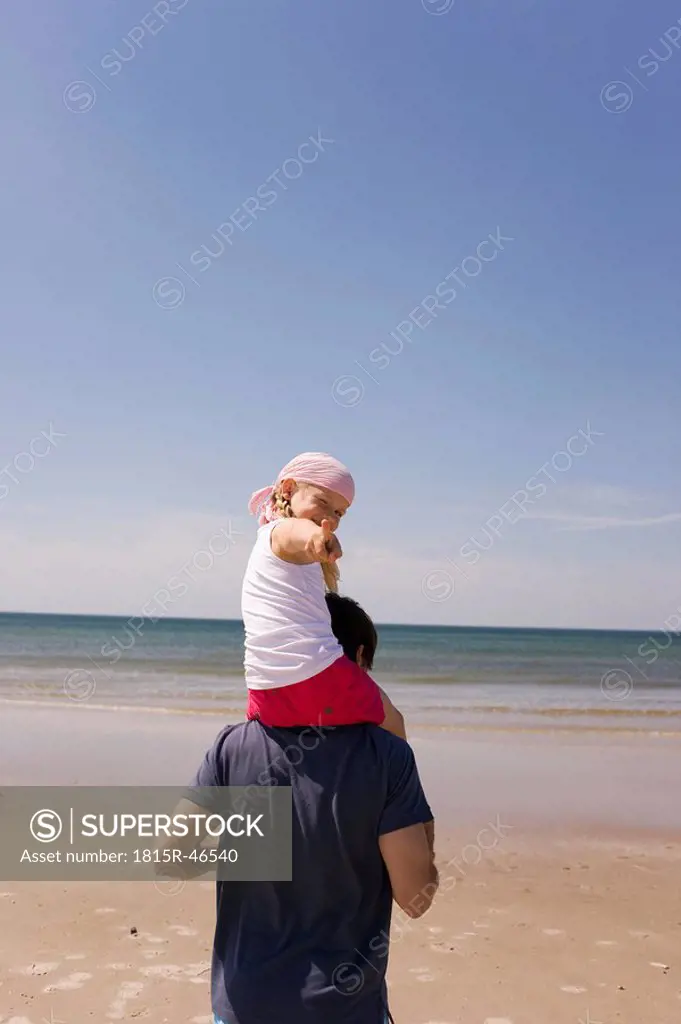 Germany, Baltic sea, Father carrying daughter 6 on shoulders