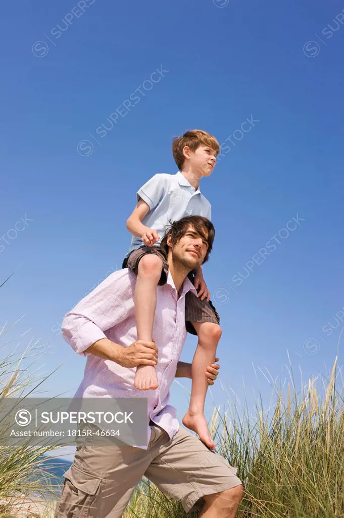 Germany, Baltic sea, Father carrying son 8_9