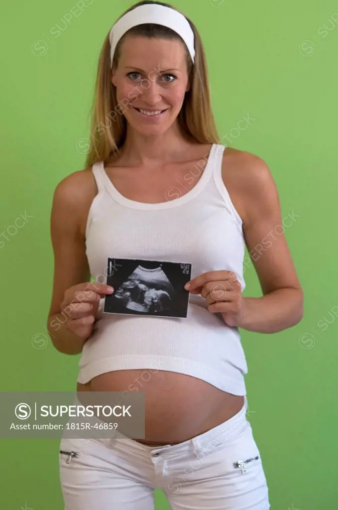 Pregnant woman holding ultrasonic picture