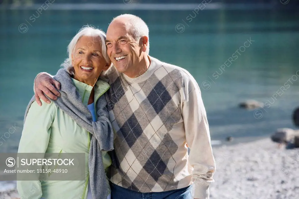 Germany, Bavaria, Walchensee, Senior couple embracing, smiling
