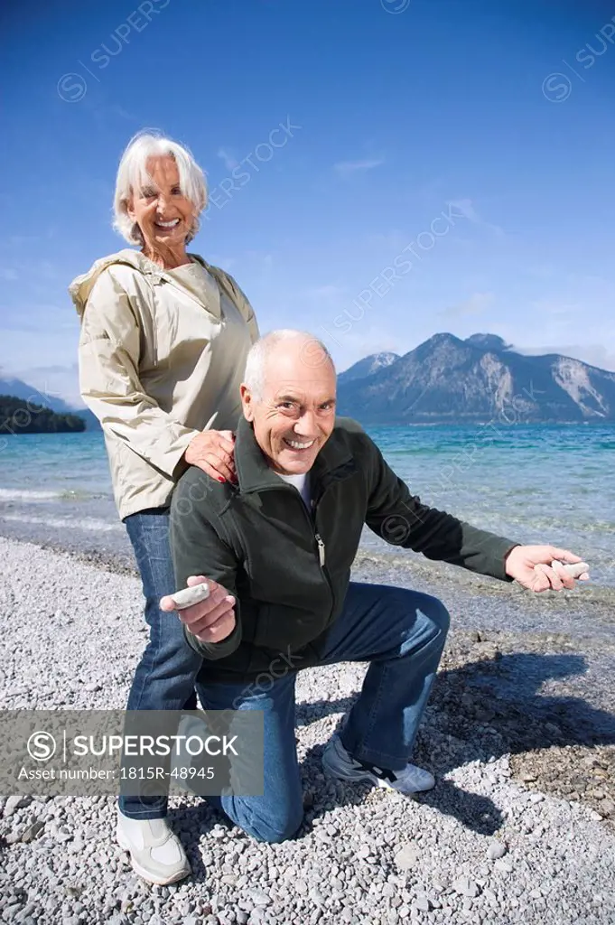 Germany, Bavaria, Walchenseel ,Senior couple fooling about on lakeshore