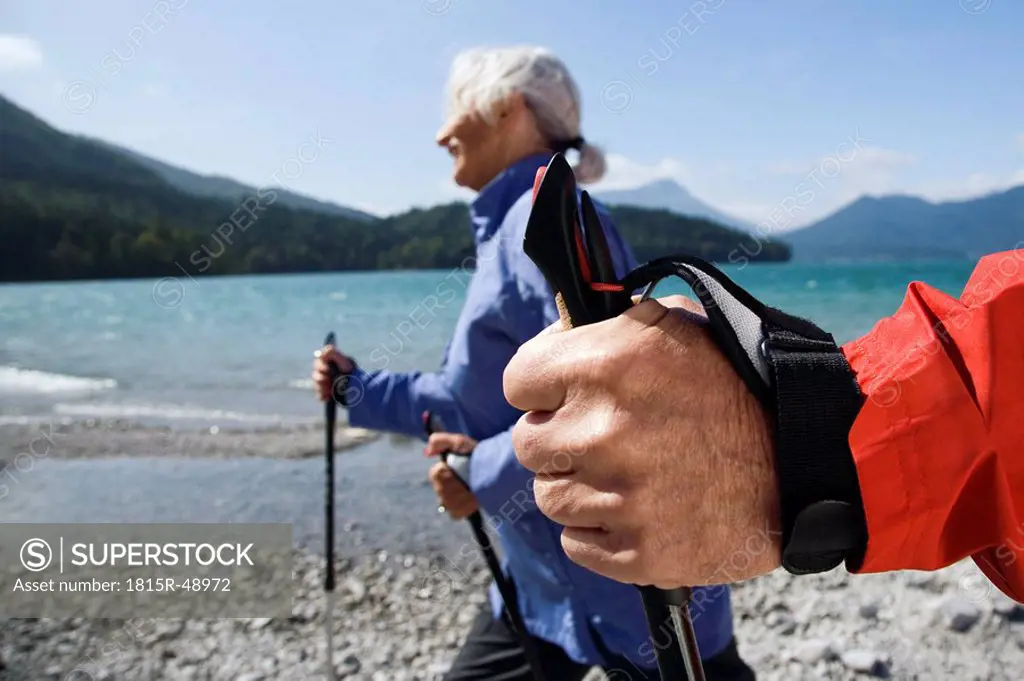 Germany, Bavaria, Walchensee, Senior couple, Nordic Walking on lakeshore